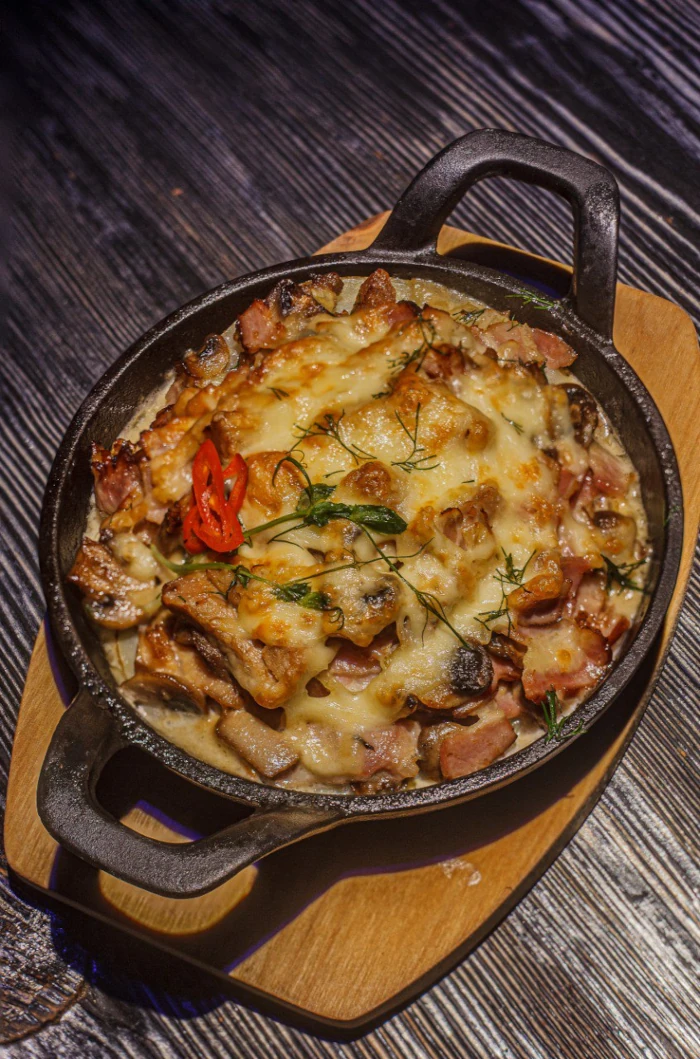 Baked potato with hunter's meat and bacon