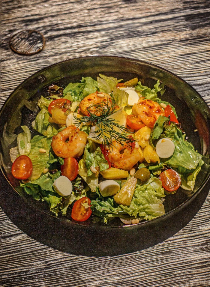 With tiger shrimps, green olives and pine nuts